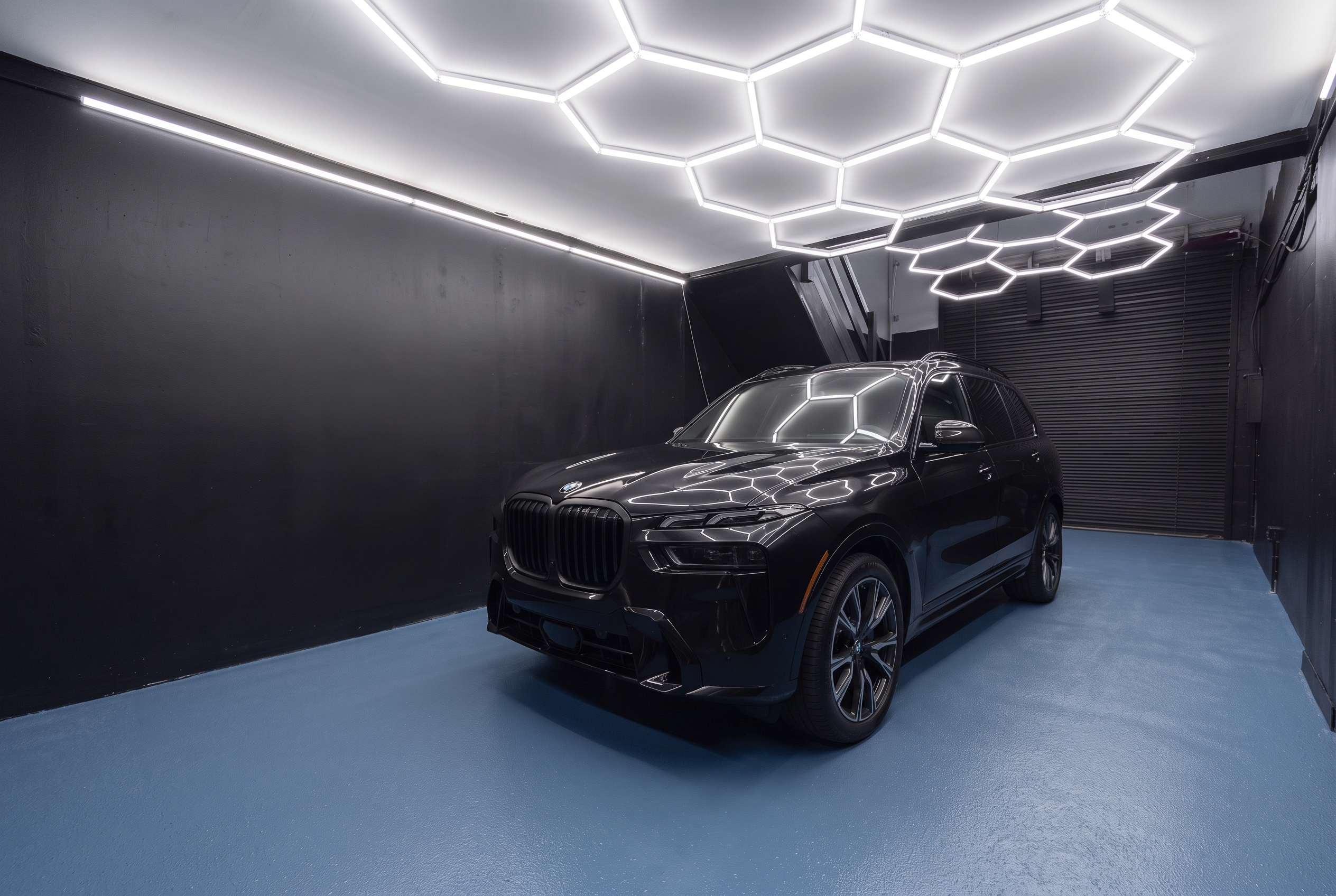 Gloss-black 2024 BMW X7 inside the Precision PPF workshop